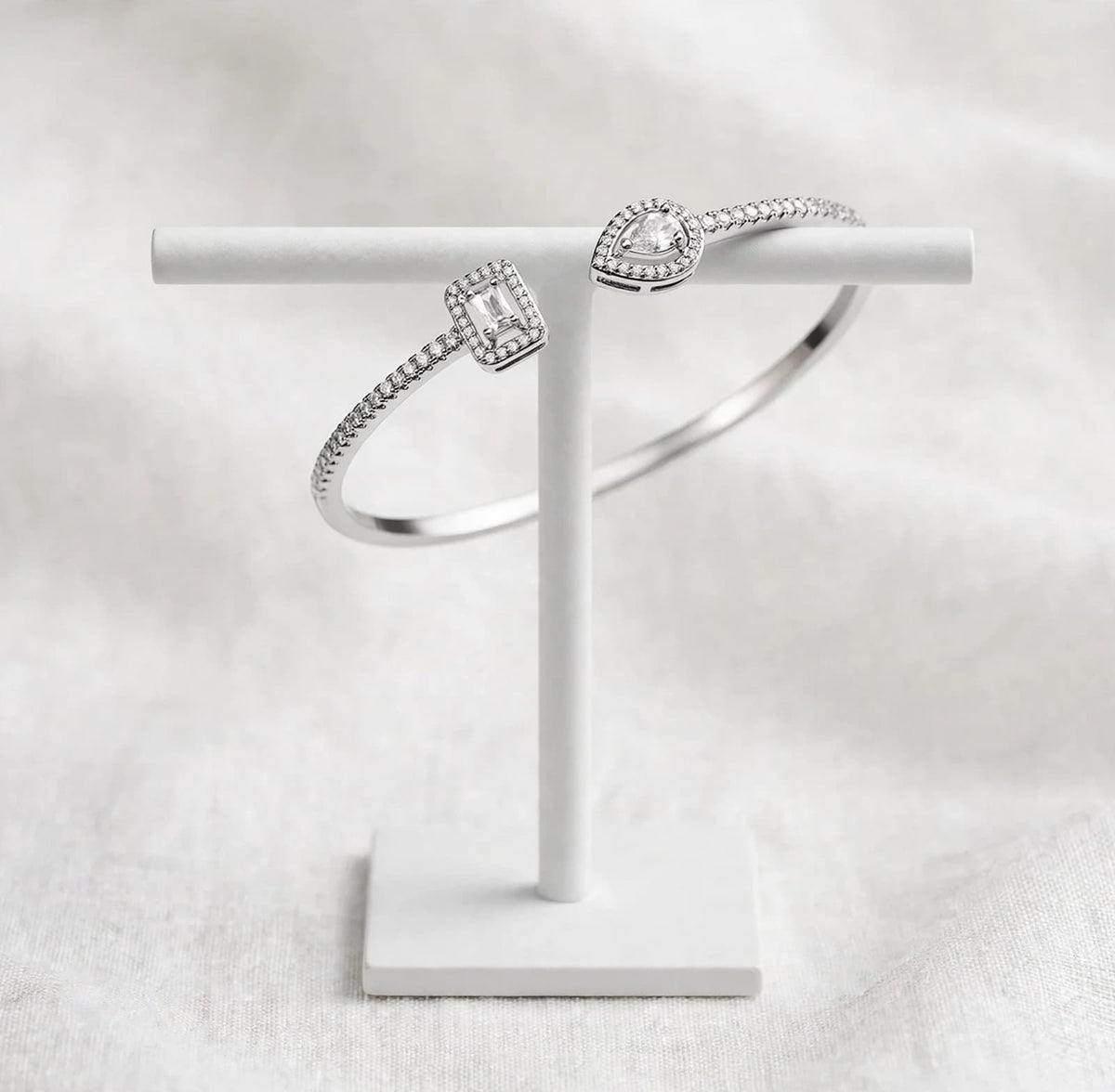 Silver-tone cubic zirconia open cuff bracelet displayed in a pink jewelry box
