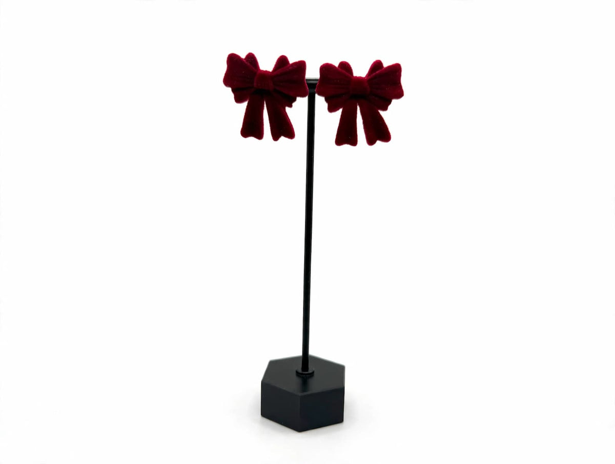 Red flocked bow stud earrings shown without decorative backs