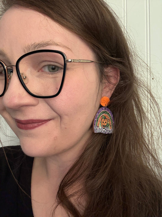 Trick or Teach earring modeled — lifestyle shot