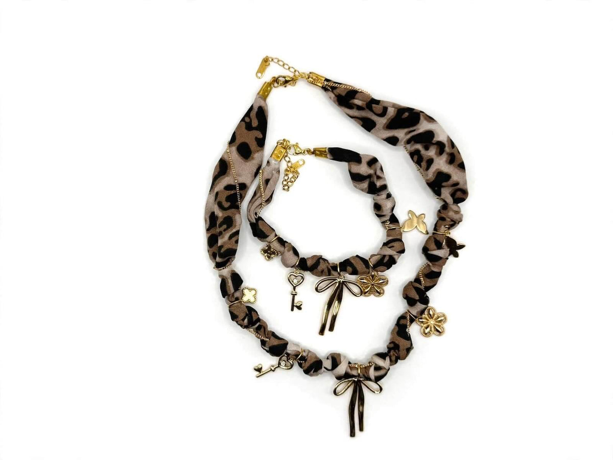 Leopard-print fabric necklace and bracelet set arranged on a white background.