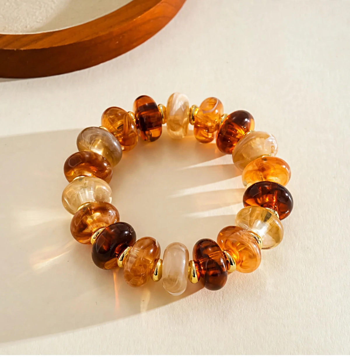 Amber-tone rondelle bead bracelet with gold-tone spacers