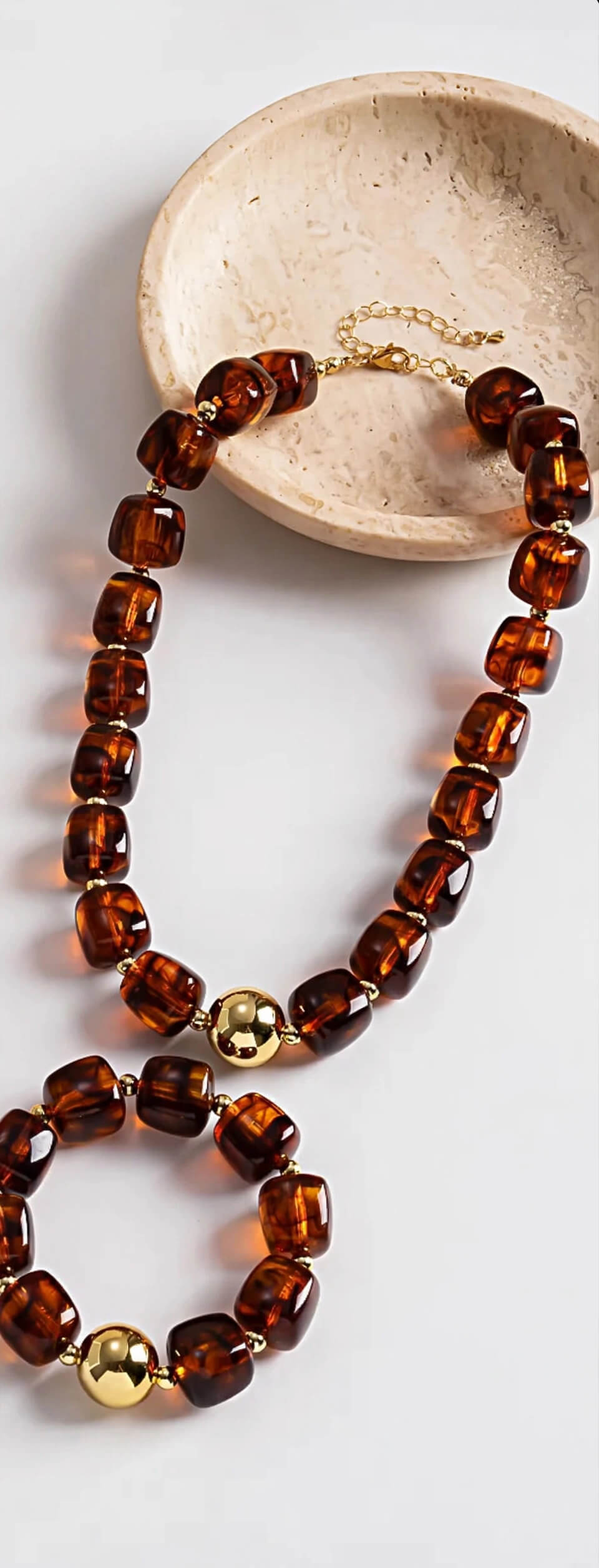 Gold color necklace and bracelet set with amber-brown chunky beads and gold-tone round accents