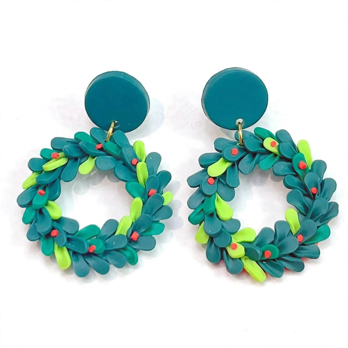 Polymer clay Christmas wreath dangle earrings with layered teal and lime green leaves, red berry accents, and round teal tops