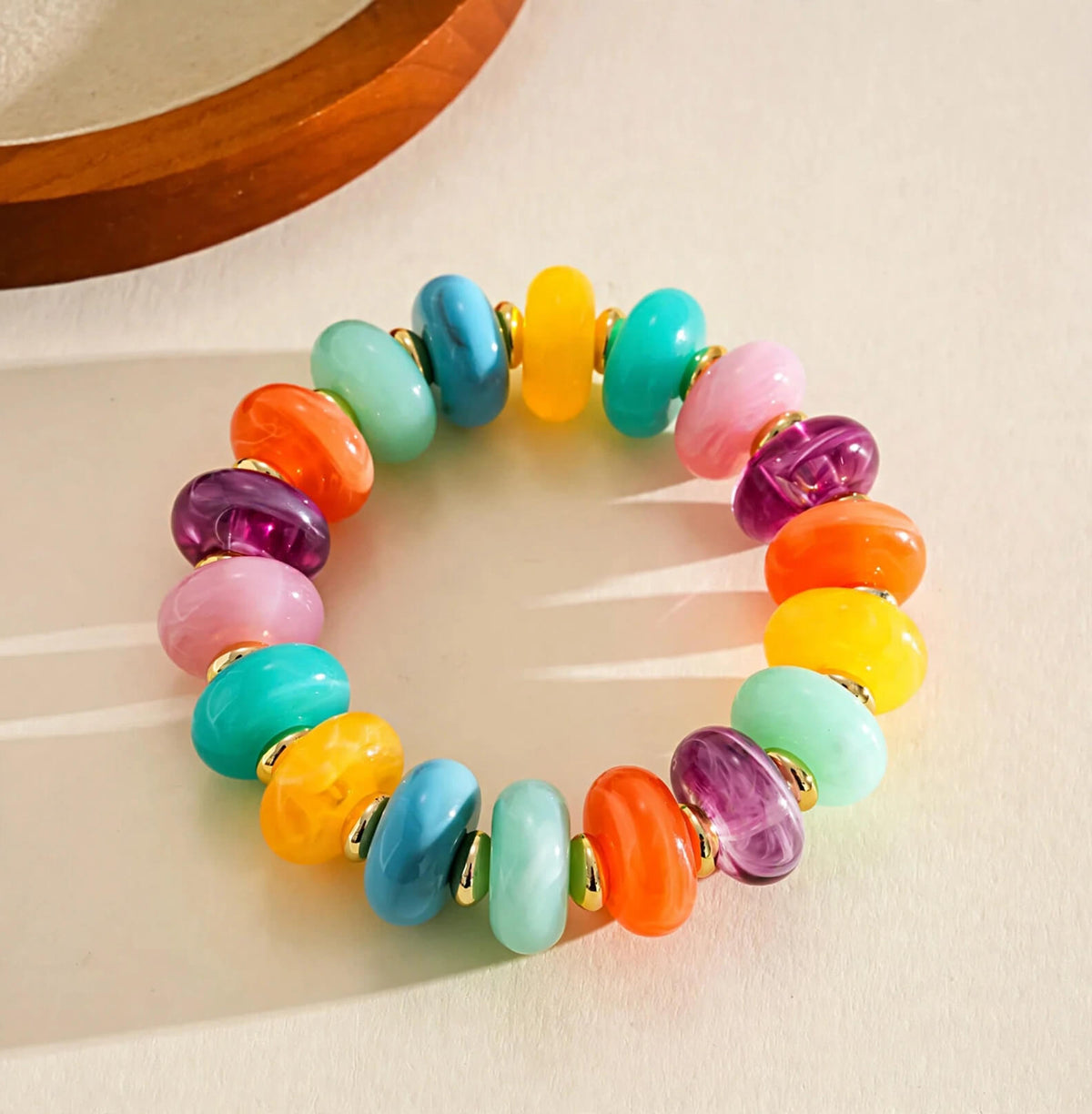 Multicolor rondelle bead bracelet with gold-tone spacers