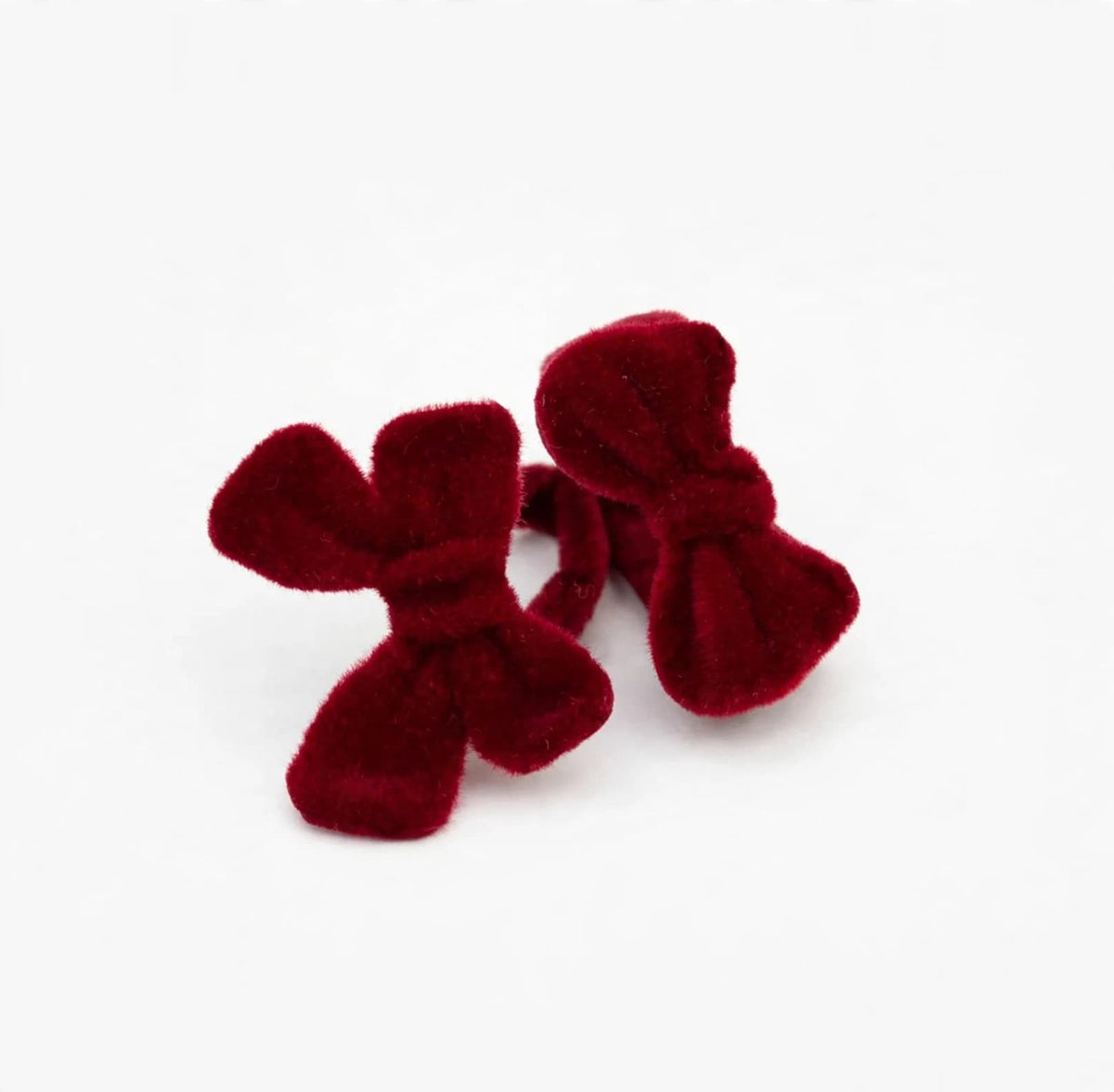 Deep red flocked alloy bow adjustable ring shown from the front on a white background
