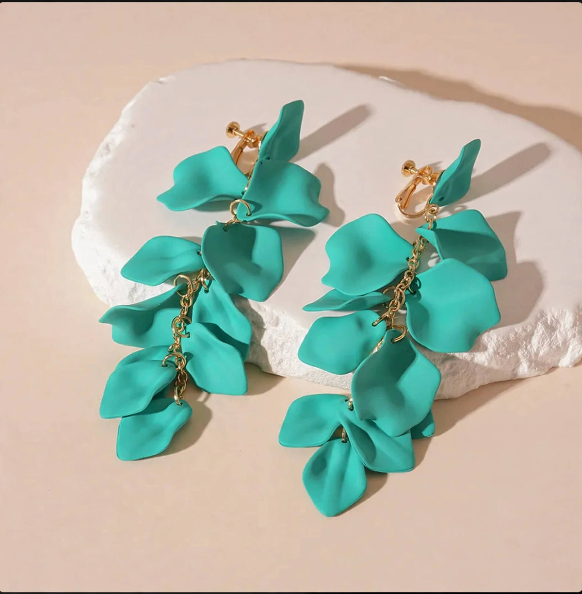 Green cascading acrylic flower petal earrings with gold-colored screw-back clip-on closures