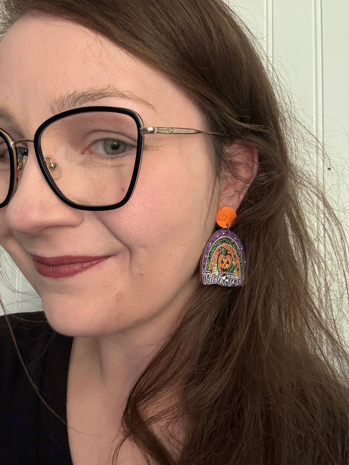 Trick or Teach earring modeled — lifestyle shot