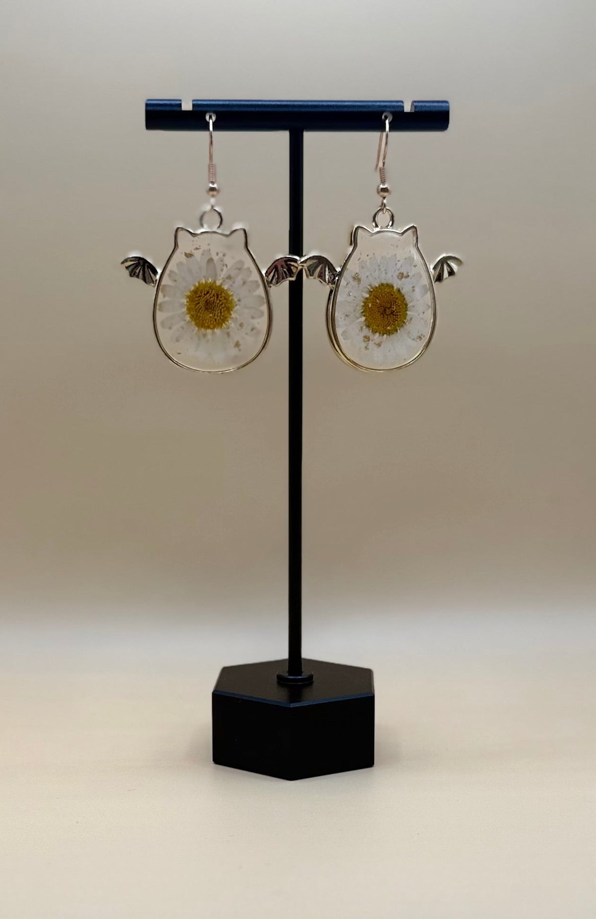 Halloween Daisy Bat Earrings on display stand