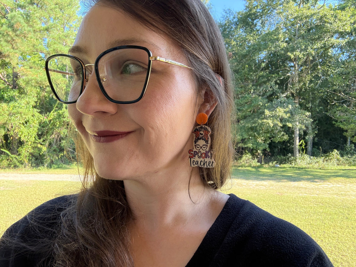 Spooky Teacher earrings modeled — full face lifestyle shot