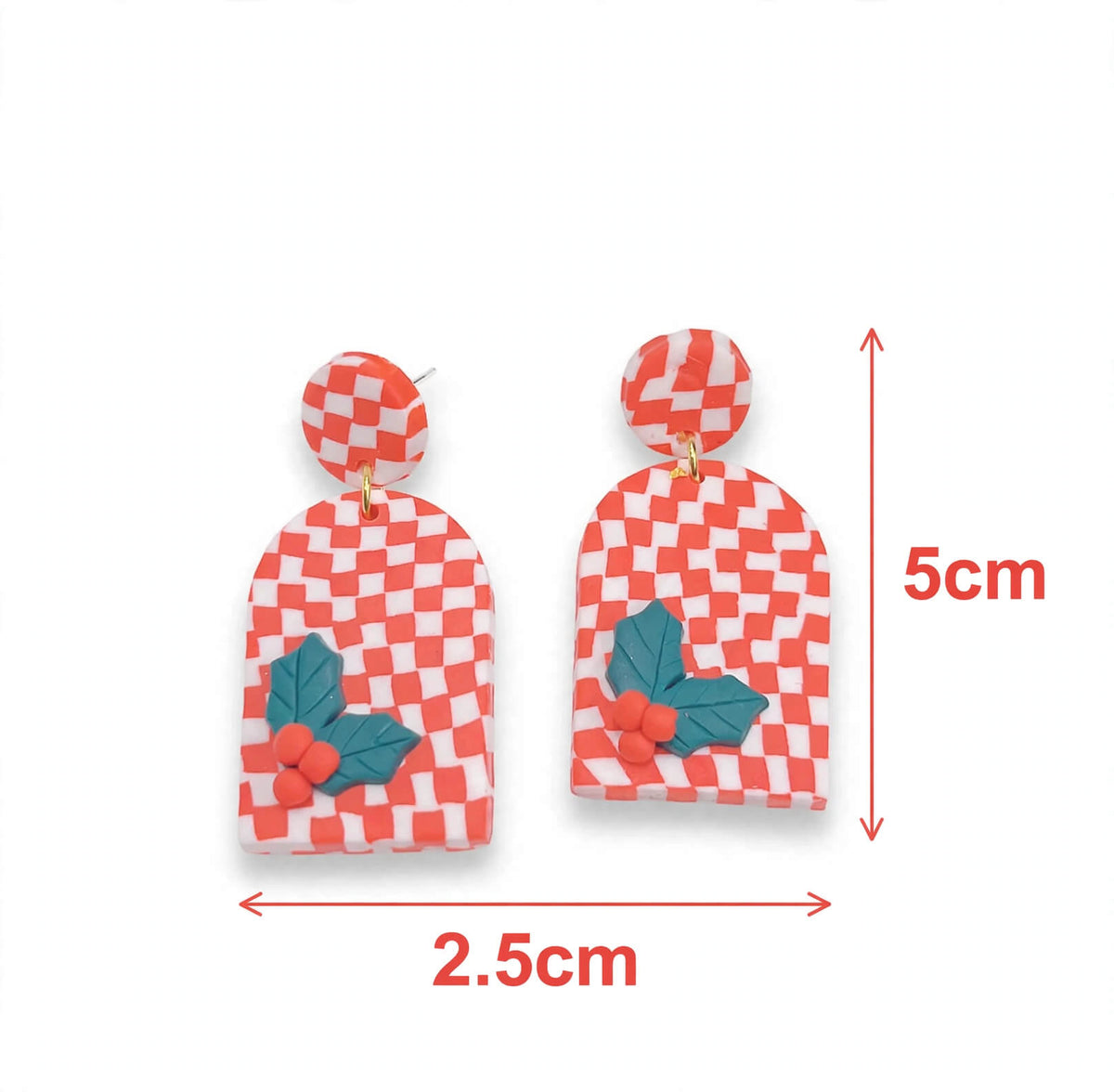 Red-and-white checkerboard clay earrings with arched dangles, raised green holly leaves, and red berries